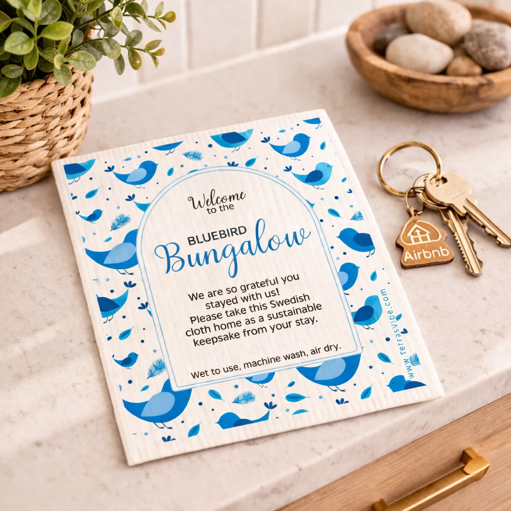 Welcome swedish cloth with blue birds and text on a table with keys and flowers