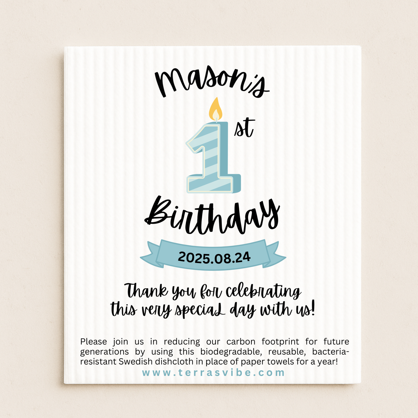 First Birthday favor with blue candle design and text on a beige swedish dishcloth background.
