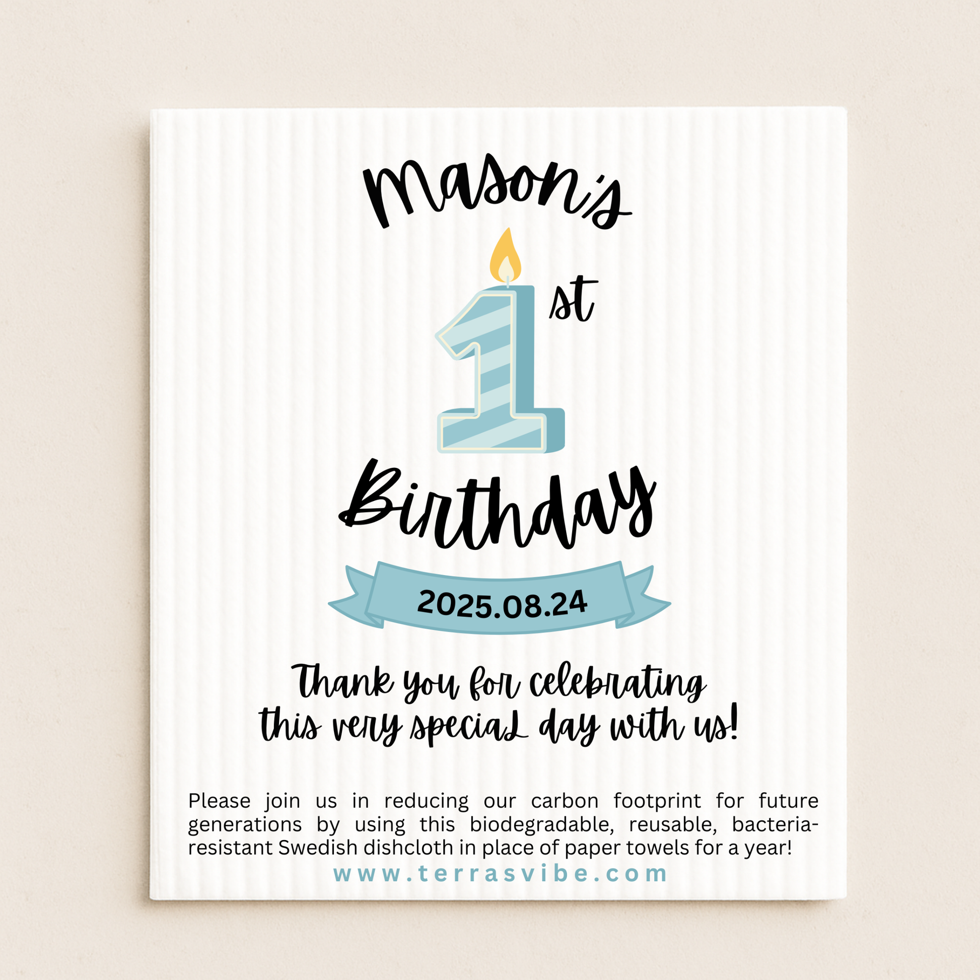 First Birthday favor with blue candle design and text on a beige swedish dishcloth background.