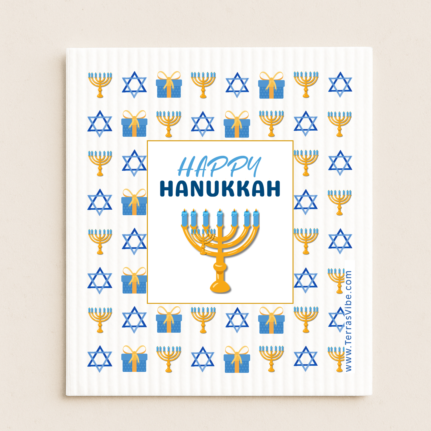 Happy Hanukkah cloth with menorah, stars of David, and presents on a white background.