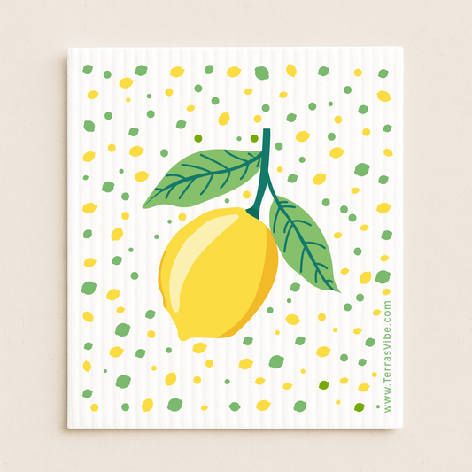 Illustration of a lemon with green leaves on a swedish dishcloth with colorful polka dots.