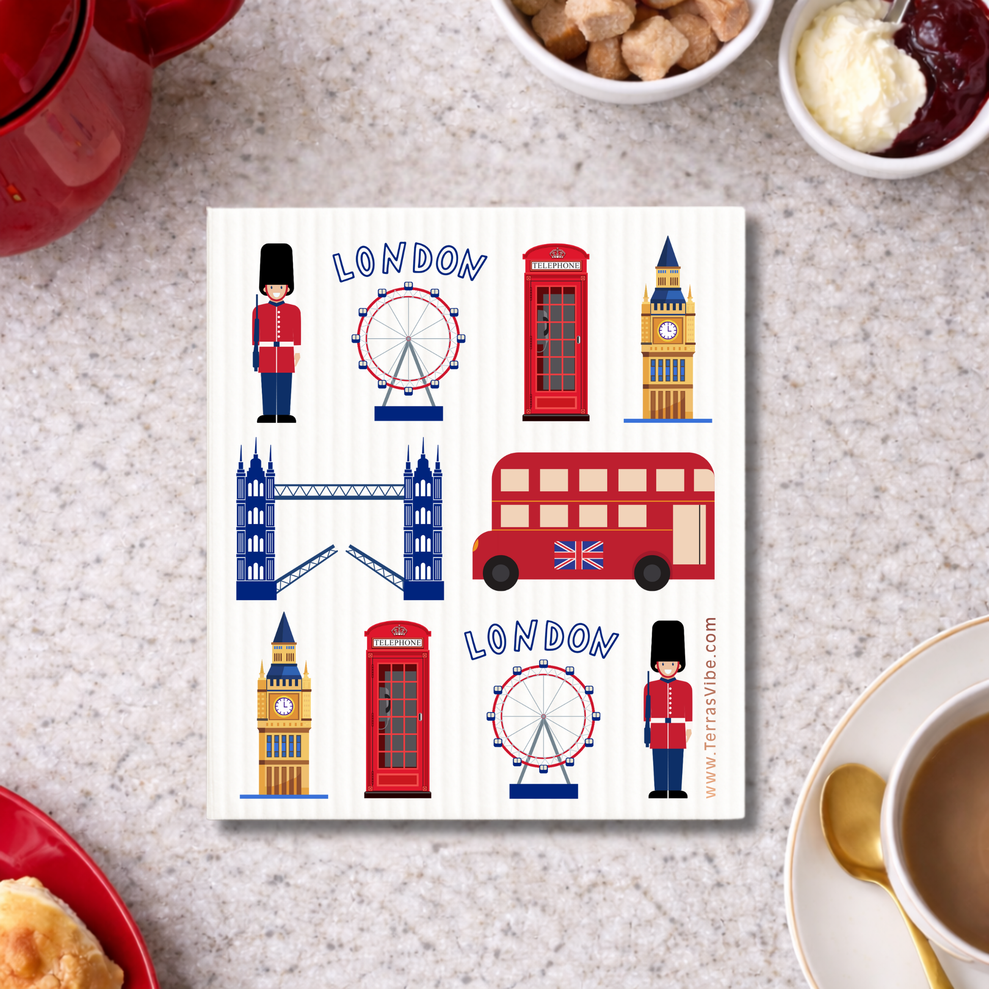 Swedish cloth with London-themed illustrations on a table with tea and biscuits.
