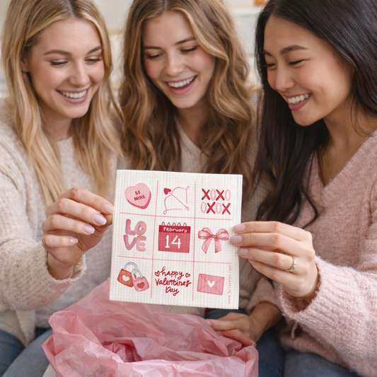 Three women looking at a Valentine's Day swedish cloth together.